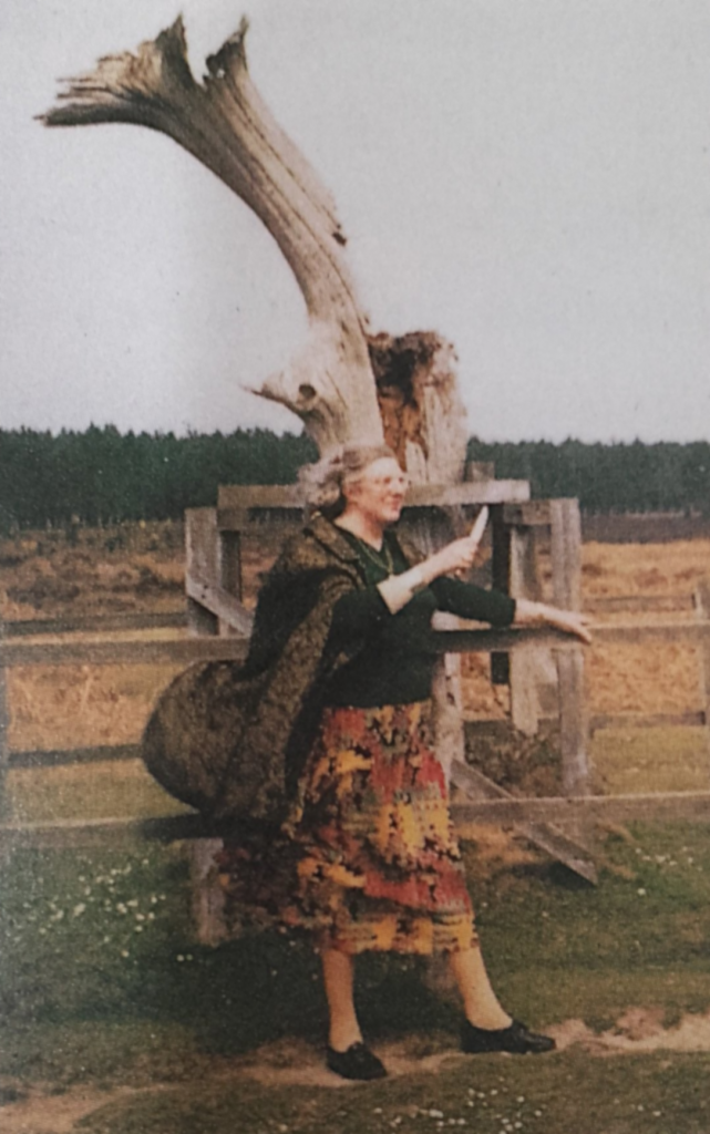 Doreen-infront-of-tree-with-cloak-blowing-in-the-wind-holding-athame