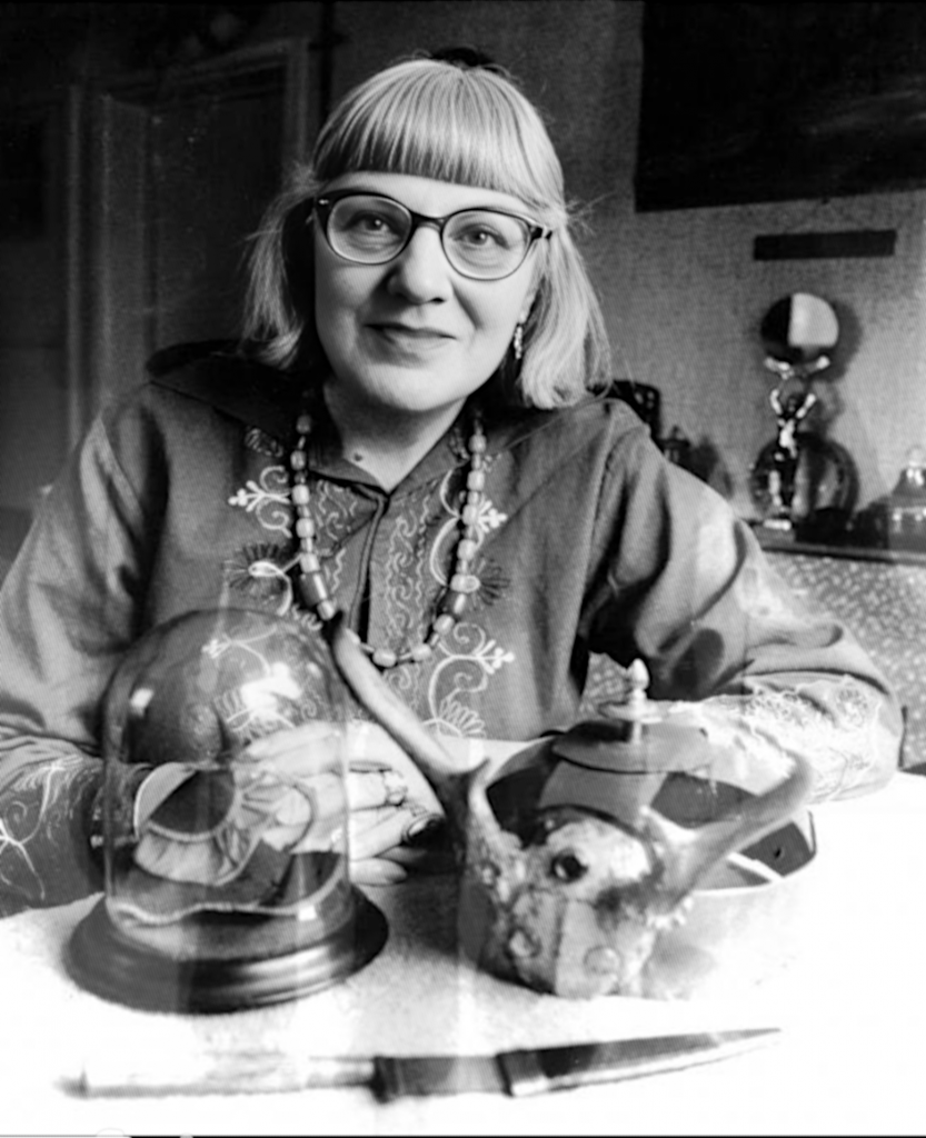 Doreen-with-horned-crown-and-bell-jar-witch-with-hand-behind-objects