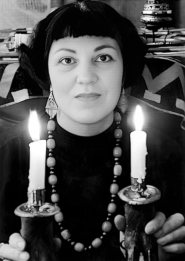 Doreen-with-short-black-hair-holding-two-lit-candles