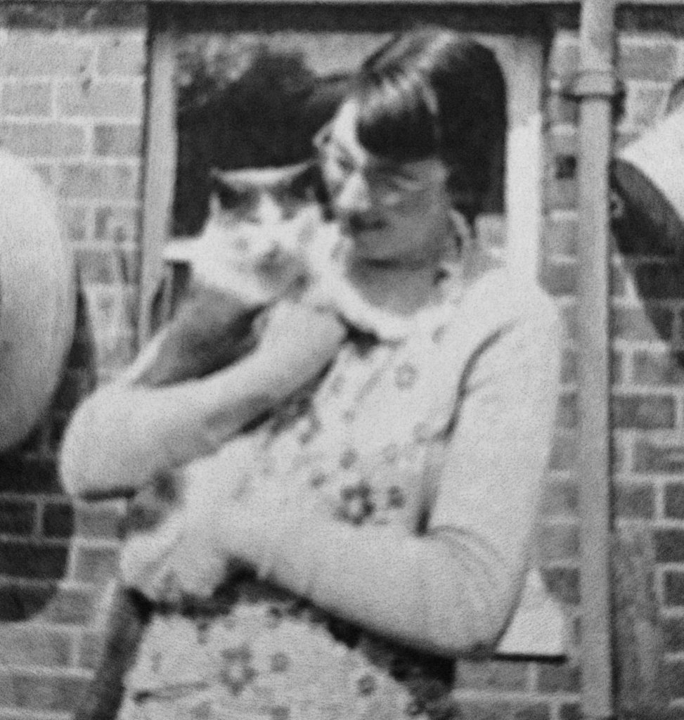 Young-Doreen-holding-cat-outside-of-a-house