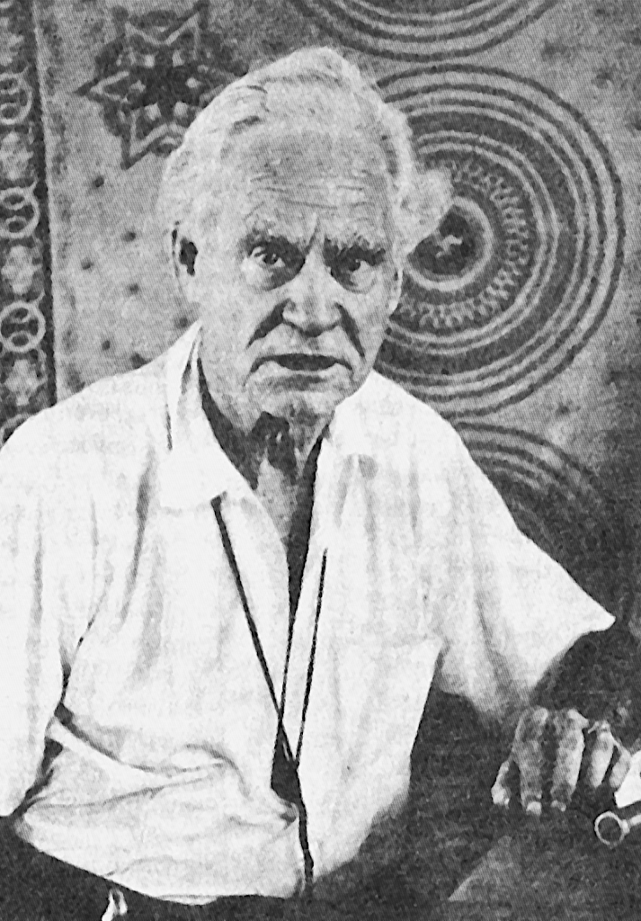 Gerald Gardner 60ish in white shirt and painted walls