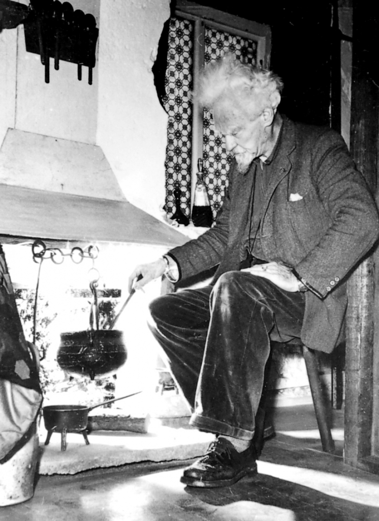 Gerald-sat-down-in-front-of-cauldron-